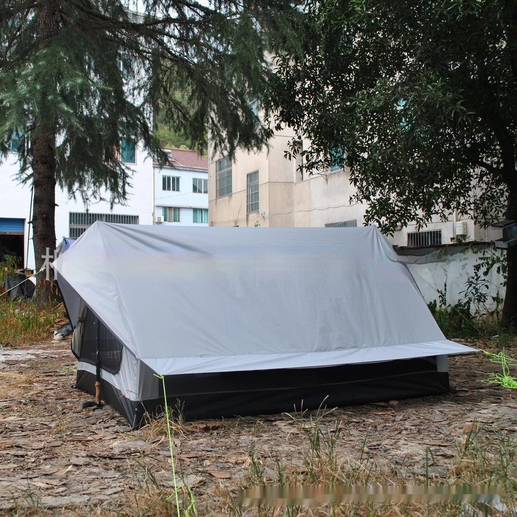 Brown A-line hiking tent erected with hiking poles showing spacious interior for 2-3 people