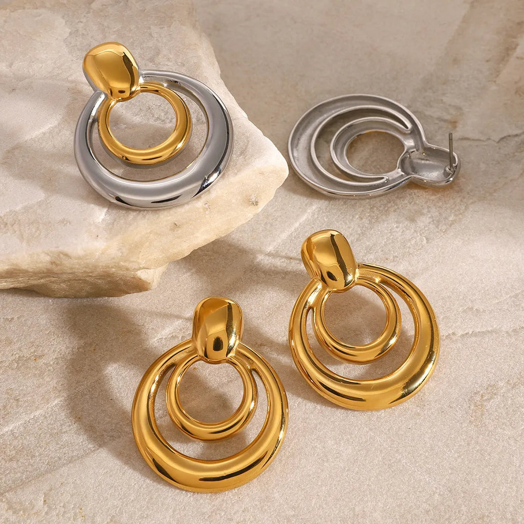 Round golden hollow stud earrings with double layer construction and 18K gold plating