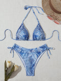 Denim blue women's bikini set with printed strap design on a hanger.