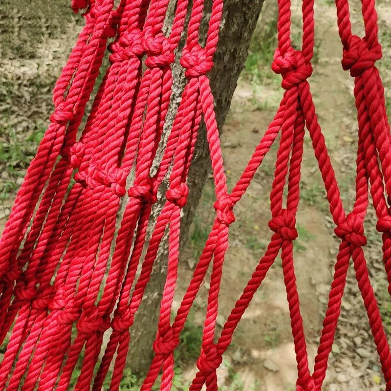 Nylon rope mesh hammock with tying system shown outdoors