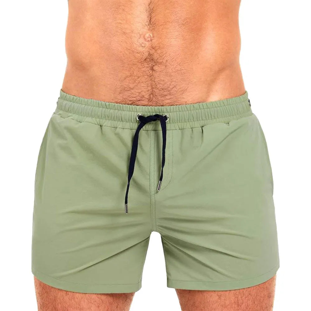 Men's solid colour swimming shorts with mesh lining in army green, shown on a white background.