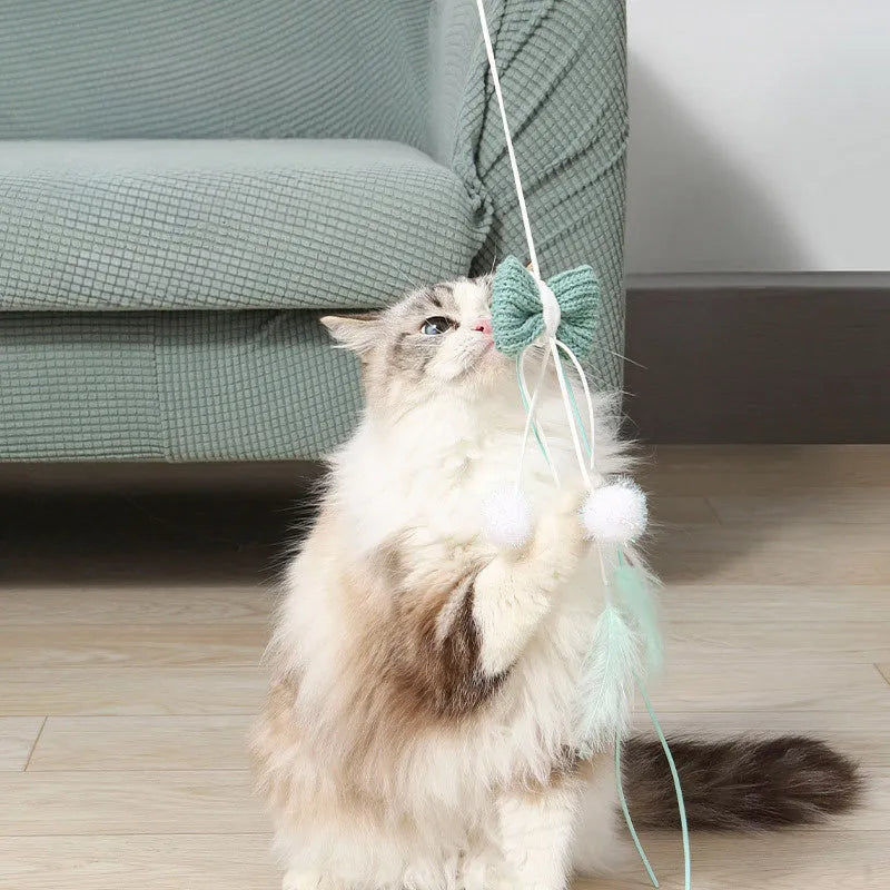 Blue cat teaser toy on a long pole with white feathers and an inflated ego component.