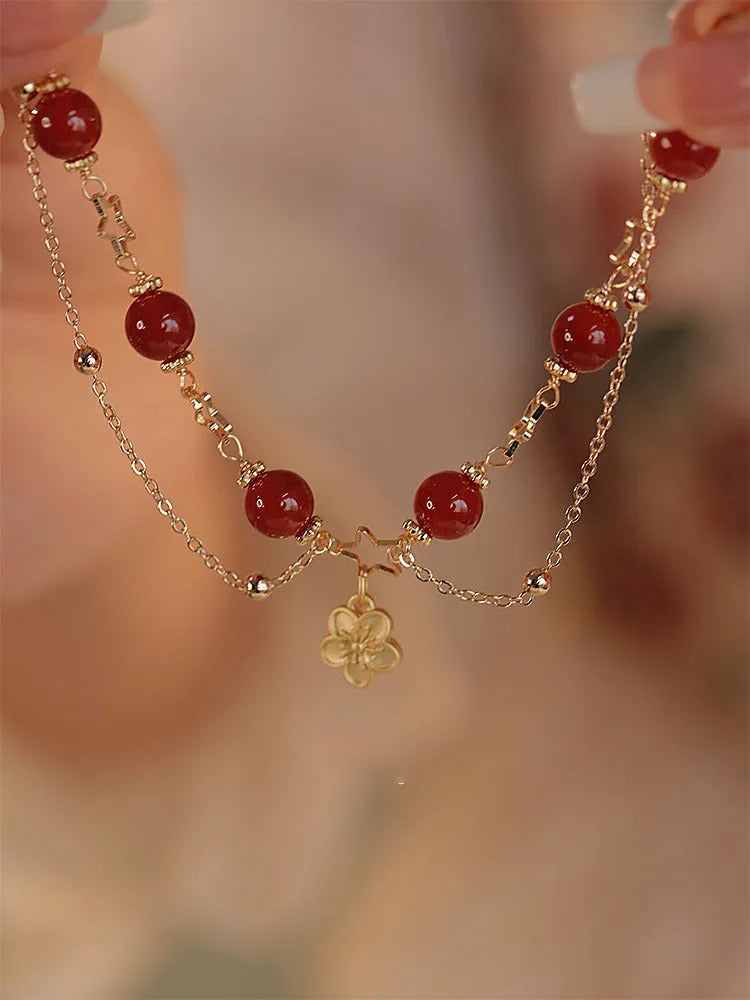 Red agate double layer women's bracelet with floral peach blossom charms on adjustable fastening