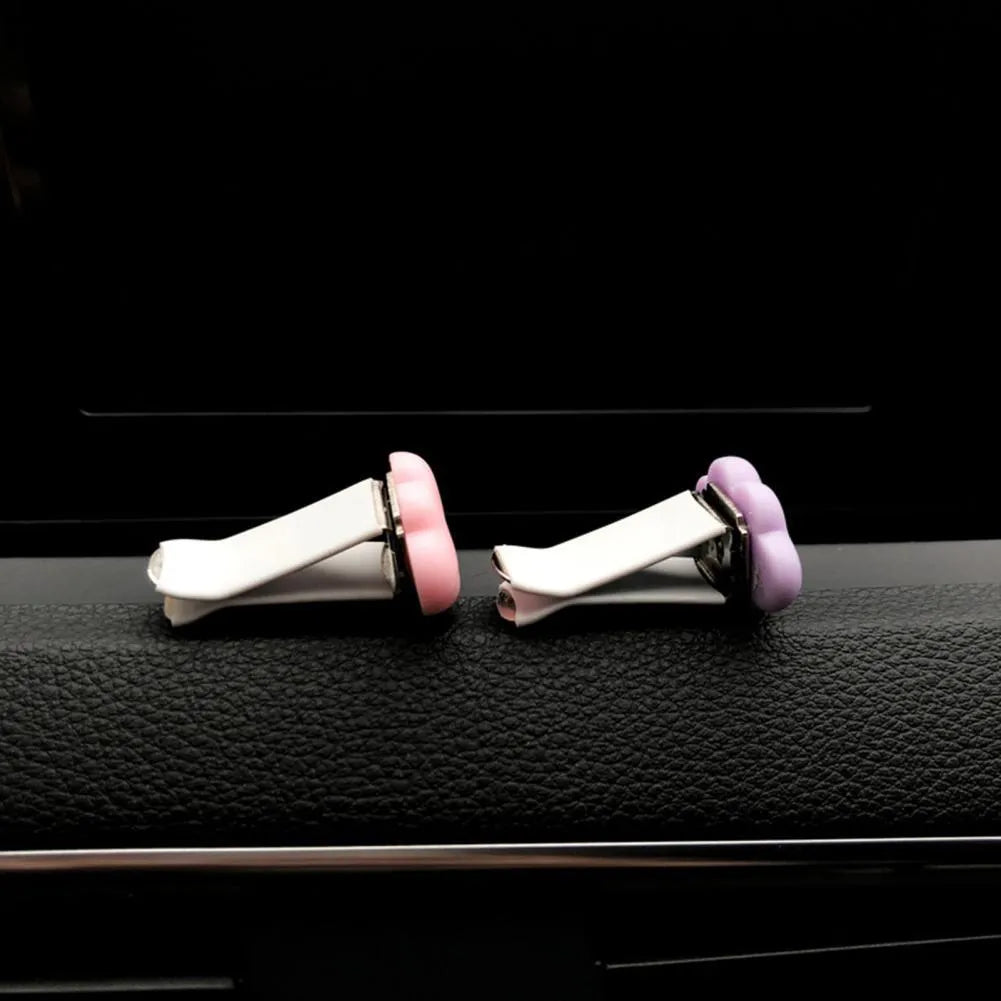 Resin cartoon cloud car fragrance clip in pastel colours mounted on vehicle air vent