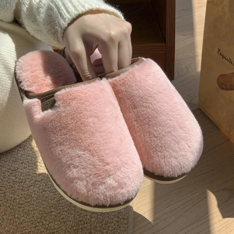 Pair of solid colour plush PVC winter slippers with non-slip soles for home use.
