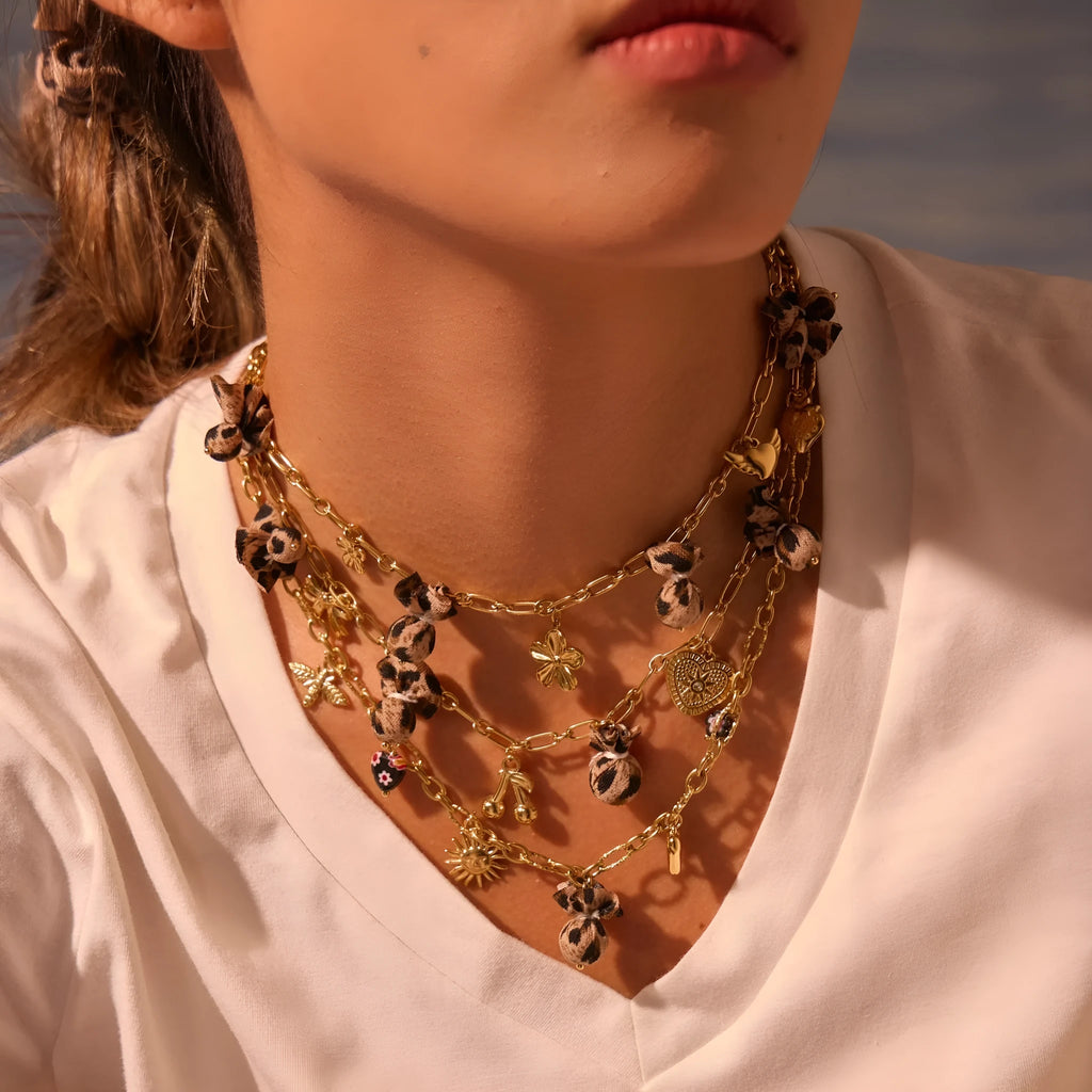 Gold plated stainless steel necklace with geometric leopard, heart, and flowers pendant on adjustable chain