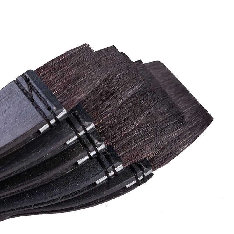 Set of five grey squirrel hair artist paintbrushes with natural wood handles, showing different sizes.