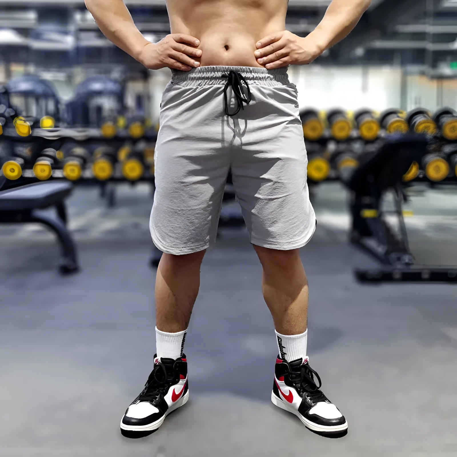 Men's black quick-drying nylon sports running shorts on a grey background.