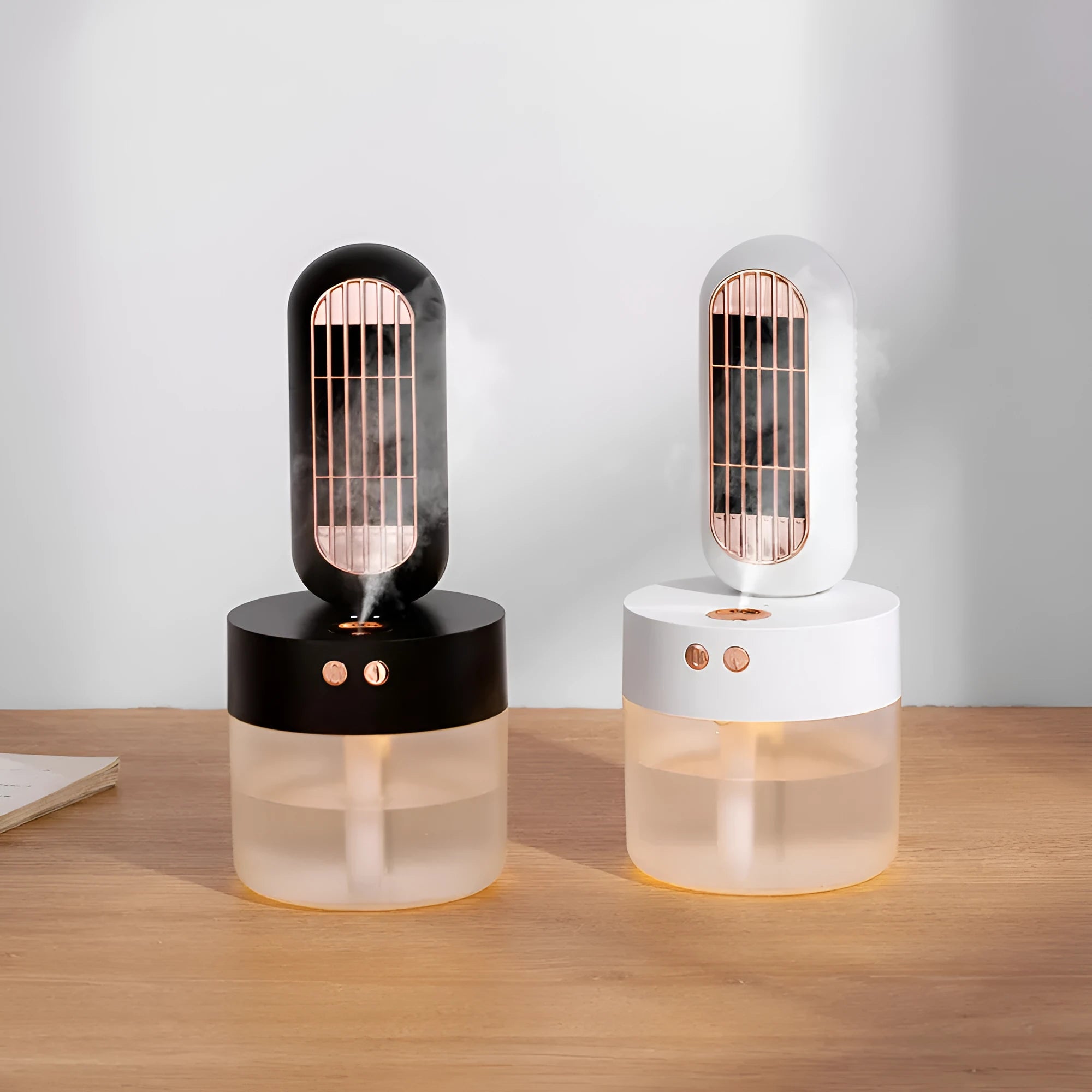 Small black and white portable humidifier fan with oscillating head on desk