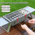 Small foldable portable charcoal grill for outdoor cooking.