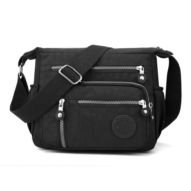 Grey nylon messenger bag with single shoulder strap showing square vertical shape