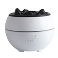 White round desktop flame aroma diffuser and humidifier with USB plug on a wooden table.