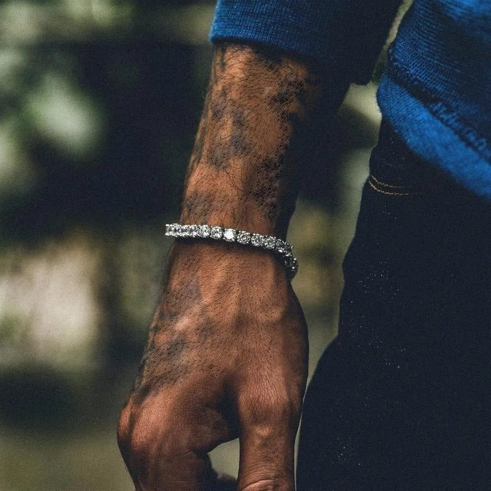 Men's silver alloy chain link bracelet with a single row of clear rhinestones on a black background.