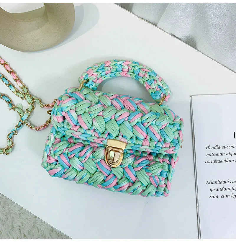 Hand knitted crochet tote crossbody bag in cotton with lock closure, yellow colour, on a plain background