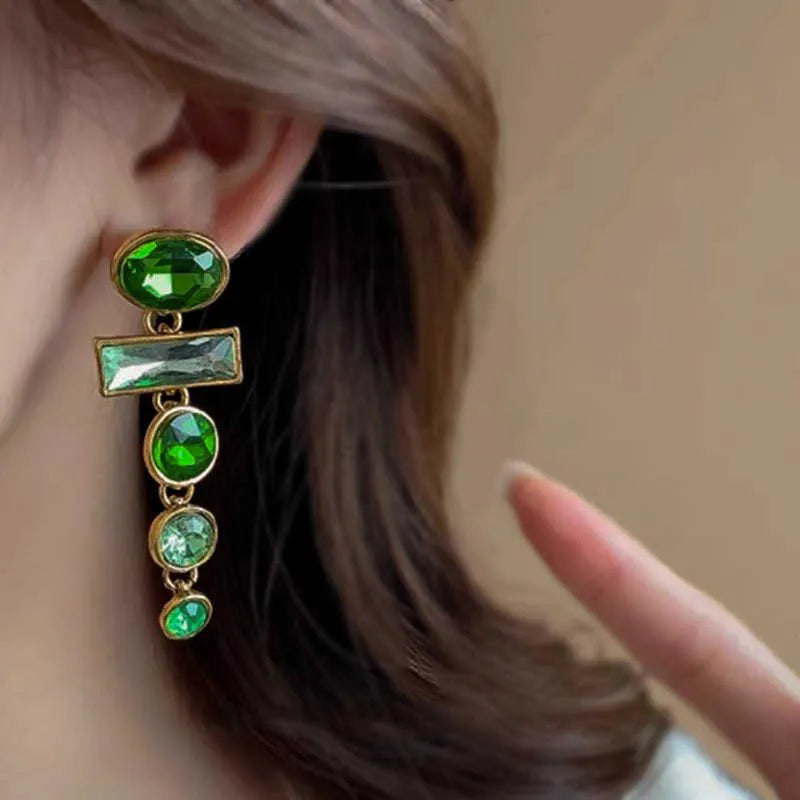 A pair of geometric green gradient alloy earrings with tassel design and inlaid zircon stones.