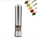 Stainless steel electric spice grinder with ceramic burrs on a kitchen counter.