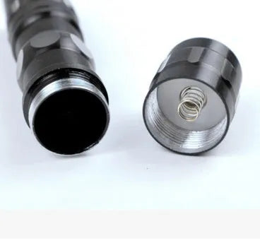 Black aluminium LED mini flashlight showing compact size with measurement scale