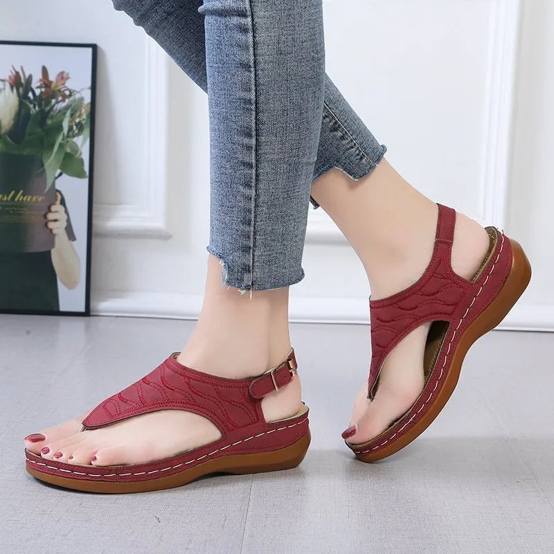 Women's casual wedge heel flip flop sandals with an adjustable buckle strap in a solid colour.