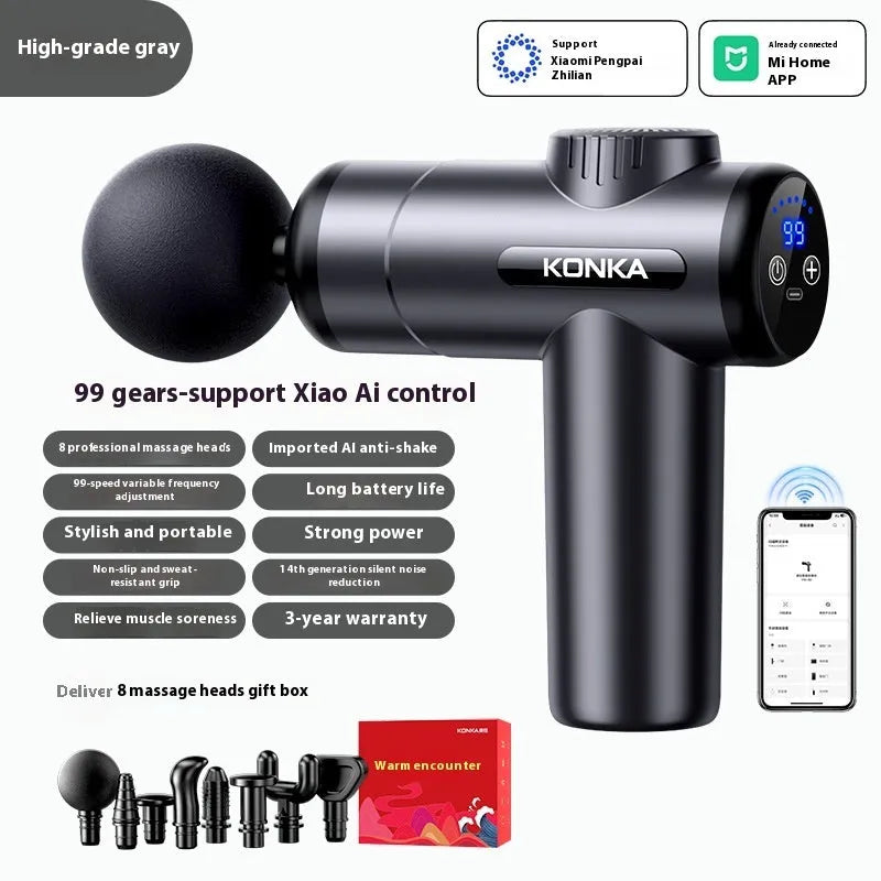 Konka V19 grey mini massage gun with multiple massage heads on a table.