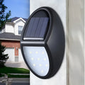Black solar-powered LED wall light with automatic sensor for outdoor garden or patio illumination