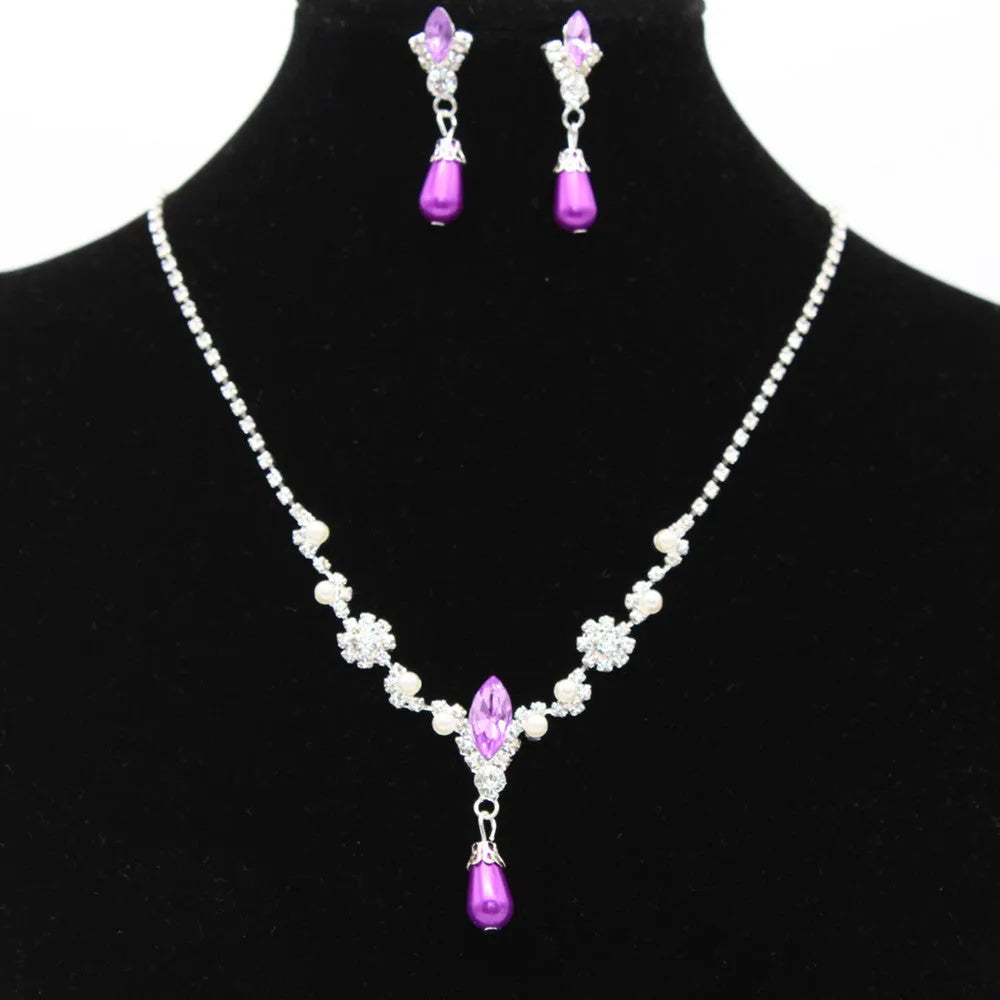 Drop pearl necklace and earrings set in white, blue, and pink for bridal and formal occasions