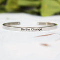 Silver customisable stainless steel bracelet with laser engraved text and adjustable fit on neutral background