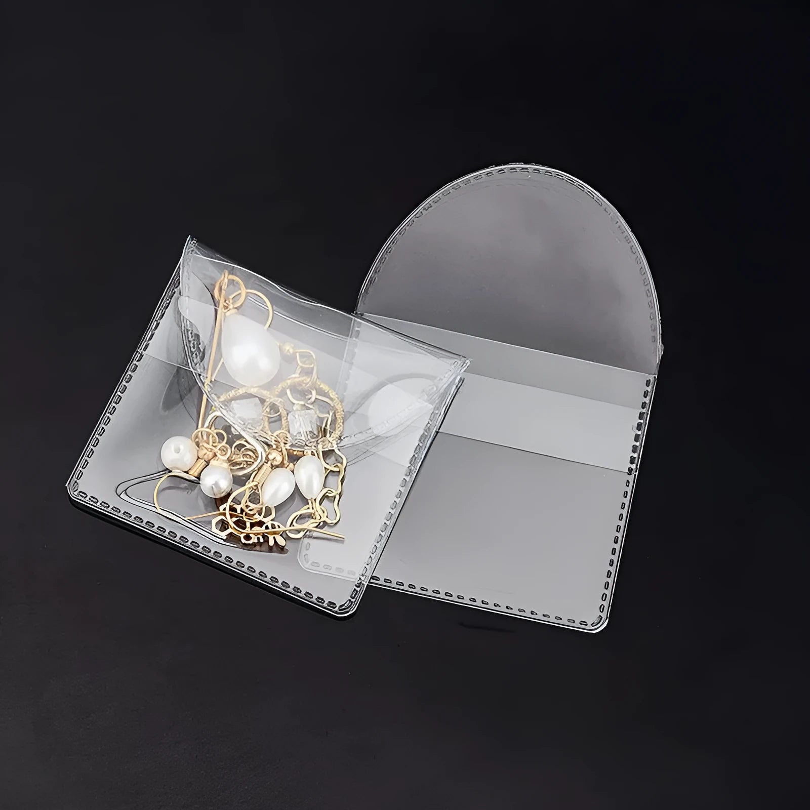 Transparent PVC soft badge bag 0.2mm thick holding coins on a flat surface