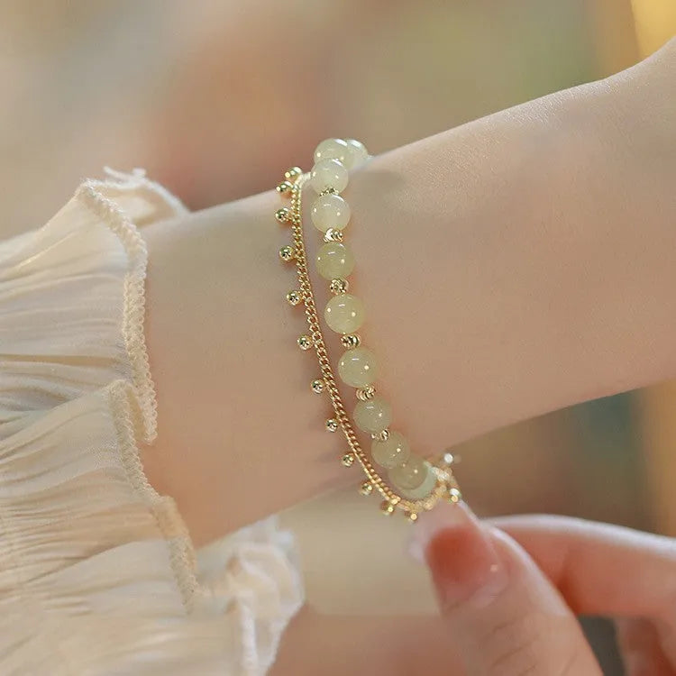 Handcrafted natural Hetian jade bracelet showing bead and charm style variations