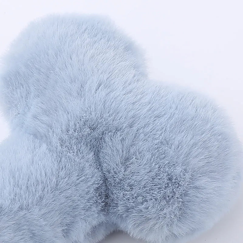 Blue squeaky plush love bone dog toy on a white background