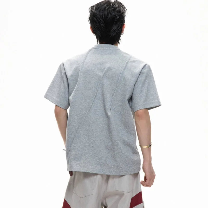 Men's loose fit grey cotton t-shirt with a textured pleated design and round neck.