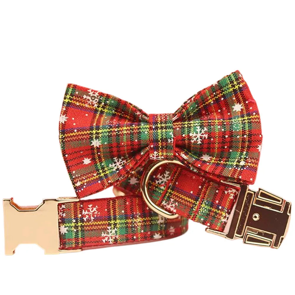 Red snowflake plaid fabric pet collar and leash set with matching dog vest and decorative bow.