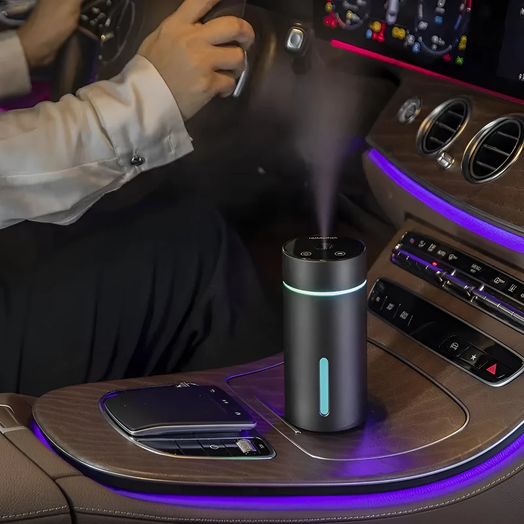 Black aluminium portable car humidifier diffuser with night light on a car dashboard