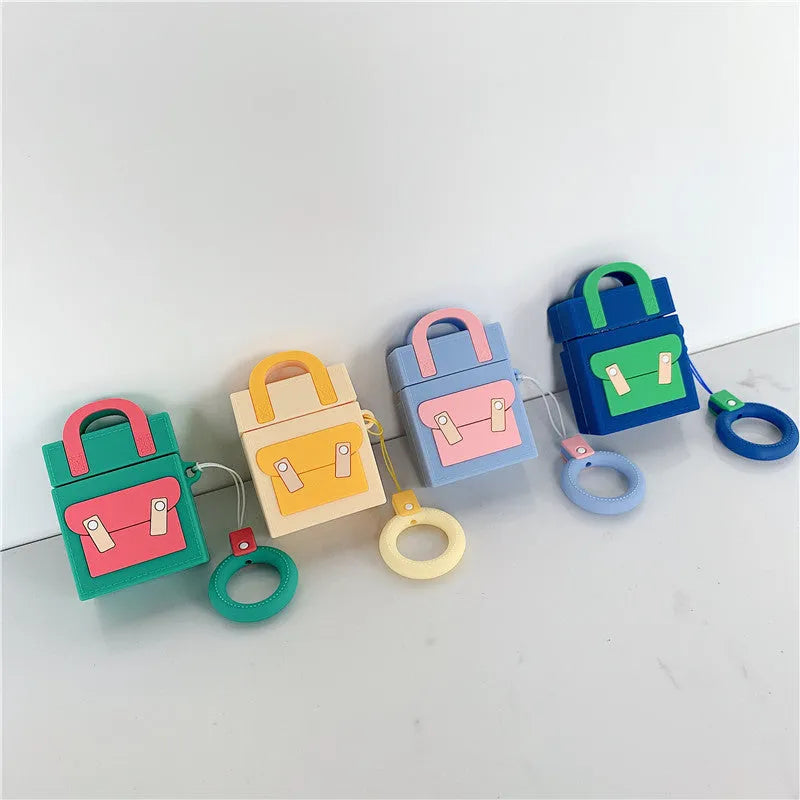 Silicone protective sleeve for AirPods 1 and 2 charging case with hanging ring, available in dark blue, green, purple, and yellow colours