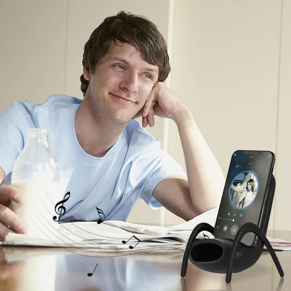 White wireless charging phone stand on a desk, charging a mobile phone at a viewing angle.