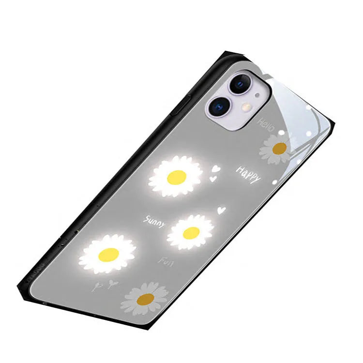 Luminous iPhone case with white daisy design and voice-activated colour lighting on a phone