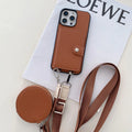 Black PC leather card holder phone case for iPhone with wrist lanyard attached.