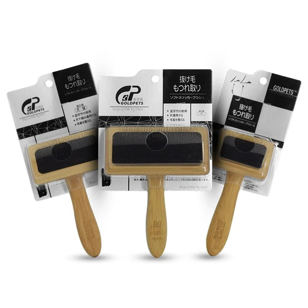 Goldpets bamboo handle pet slicker brush with stainless steel pins on wooden surface
