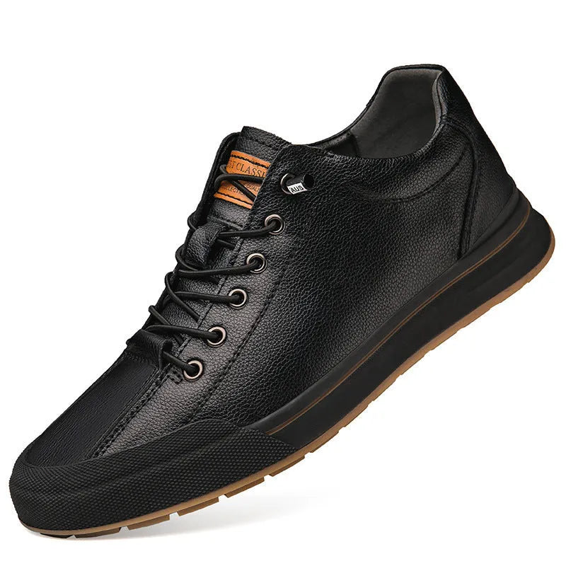 Men's white and black leather round toe flat casual trainers on a plain background.