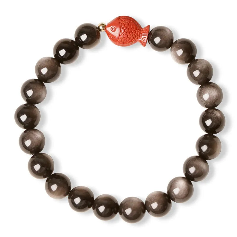 Natural obsidian round bead bracelet with red cinnabar fungus decorative elements.