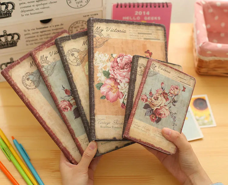 Hardcover notebook with retro floral cloth cover in Lily colour, showing 25K size next to 50K size comparison
