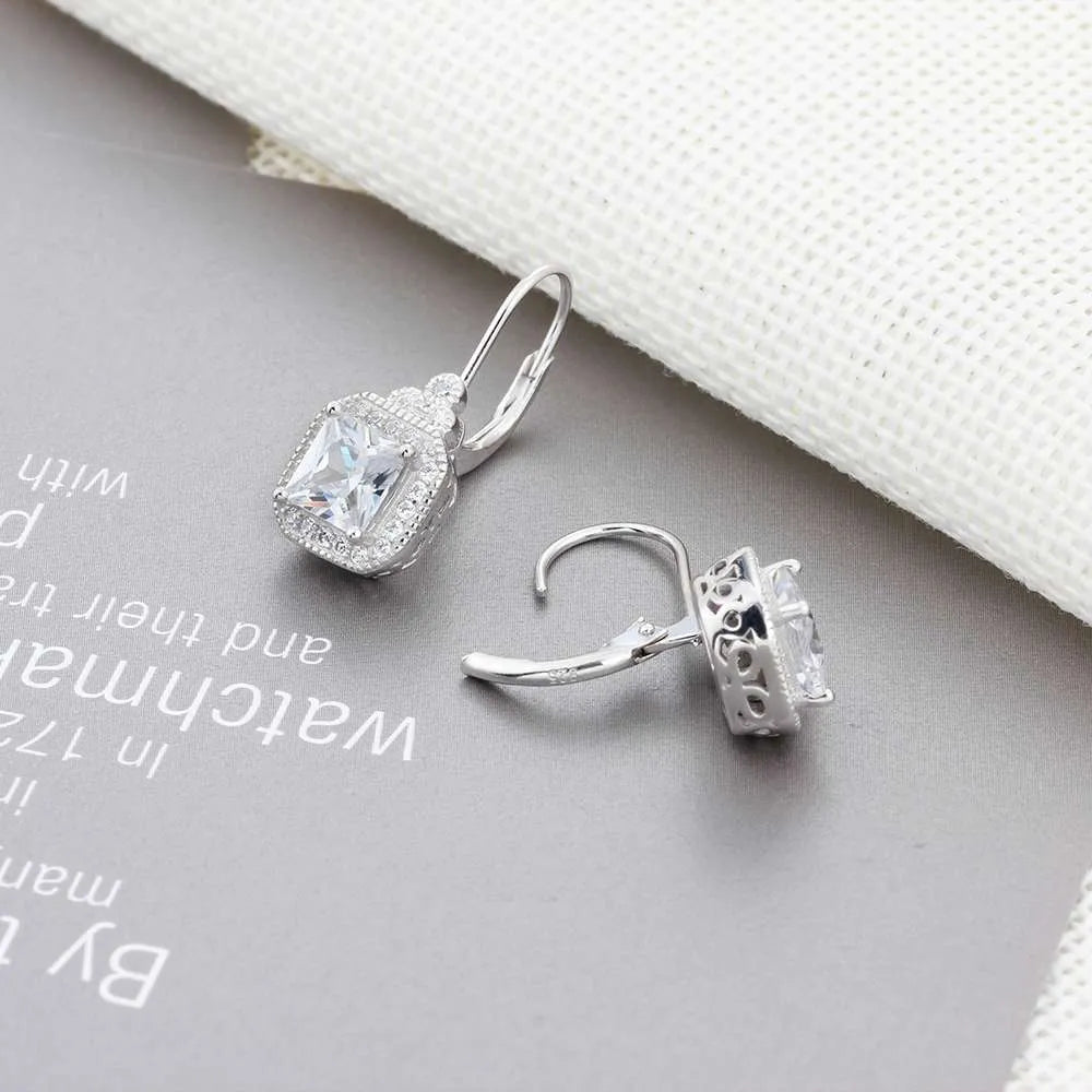 s925 sterling silver crown rhinestone earrings on a white background, polished silver finish with clear stones
