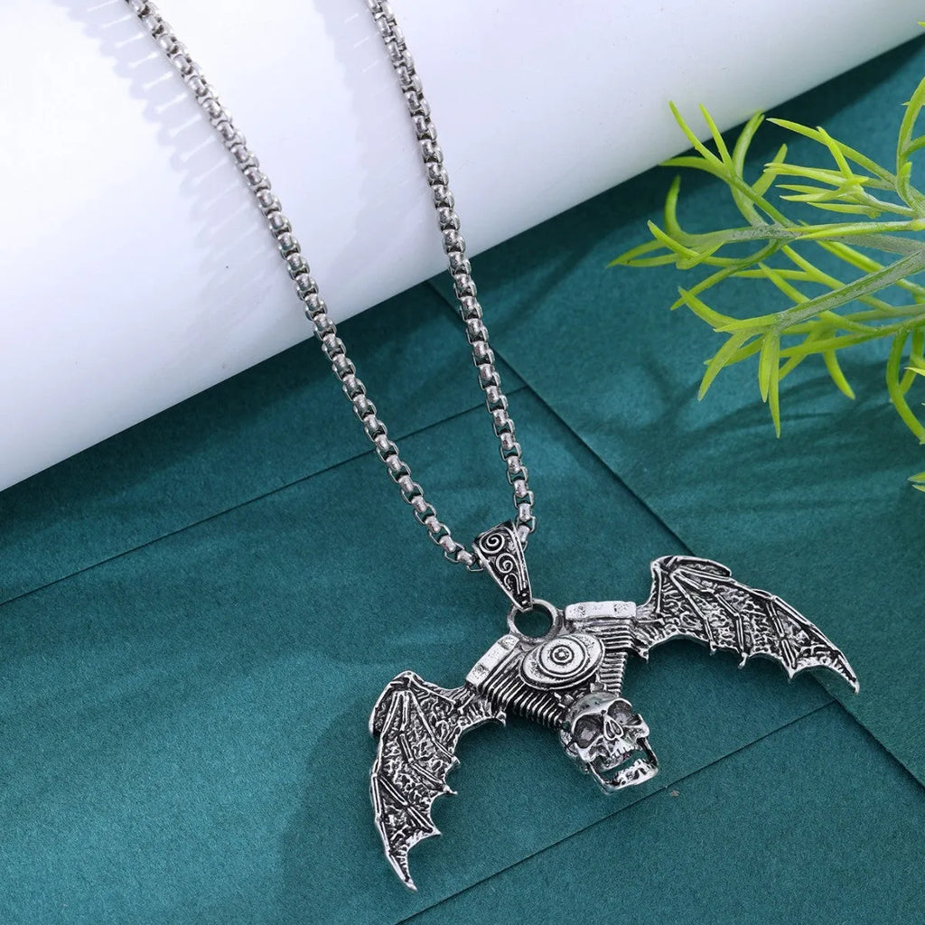 Gothic dark skull alloy necklace with skeleton wing pendant on display