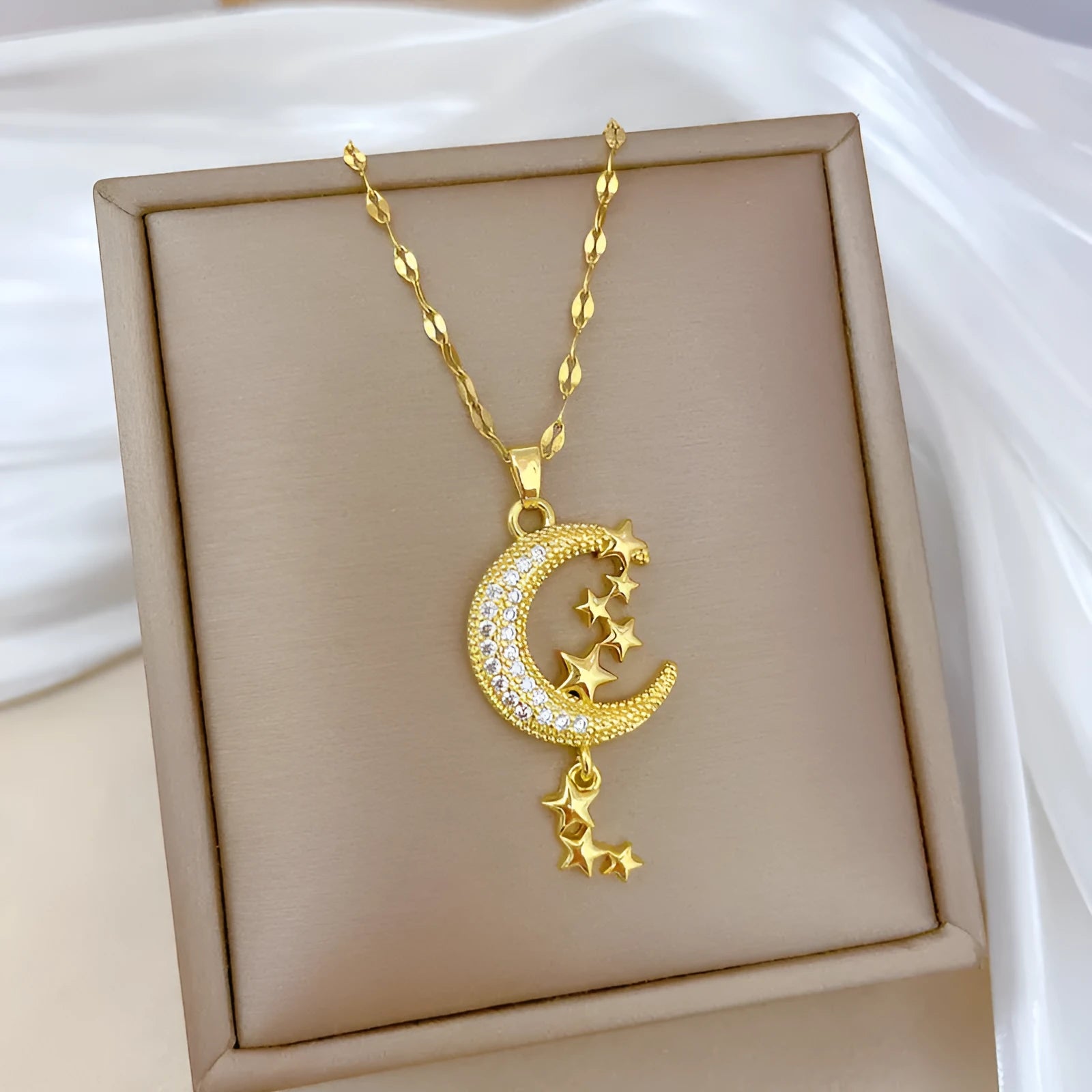 Stainless steel necklace with a geometric moon pendant and tassel chain detail.