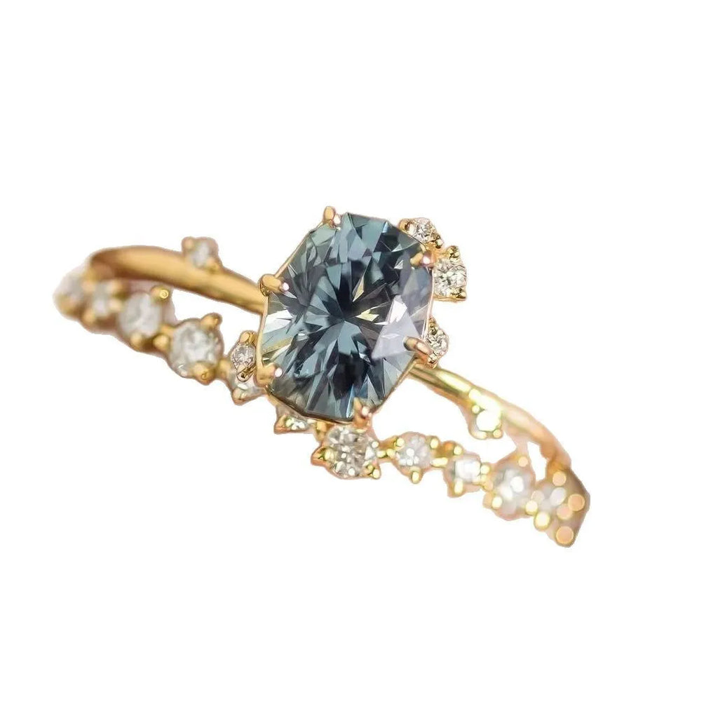 Gold plated floral fashion ring with green zircon stone inlay on finger