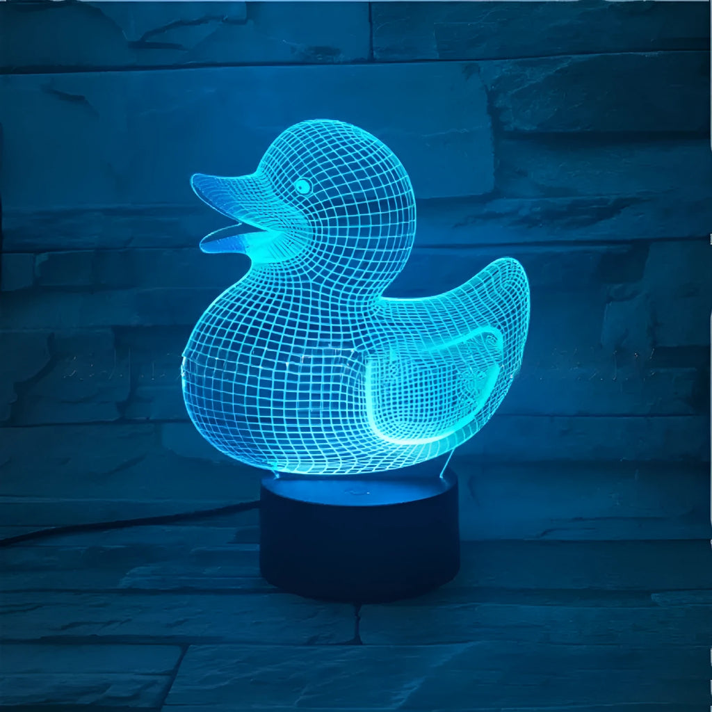 Little yellow duck 3D night light on table showing multiple colour options