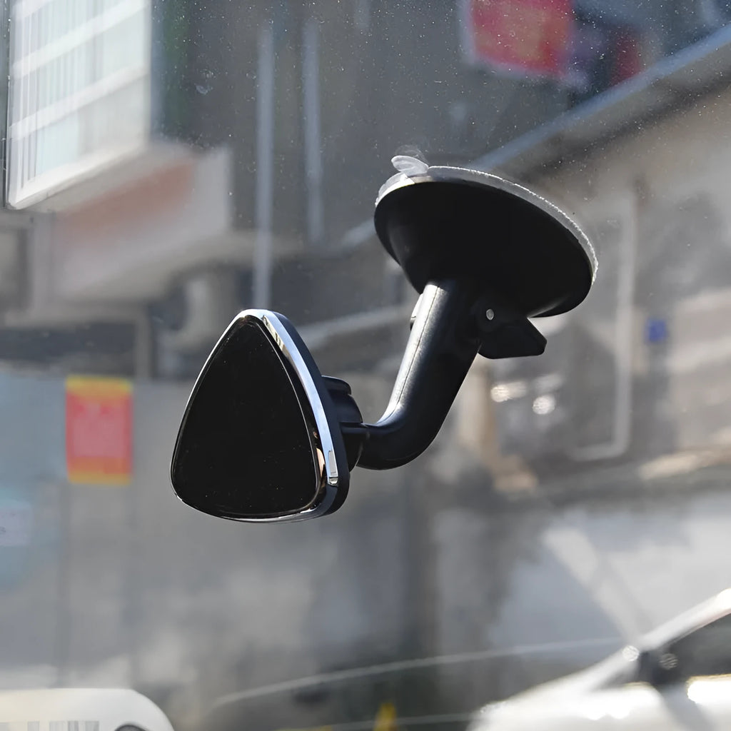 Black magnetic car phone holder with 360-degree rotating bracket mounted on dashboard
