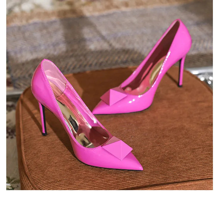 Women's pink patent leather pointed toe stiletto high heels with buckle detail