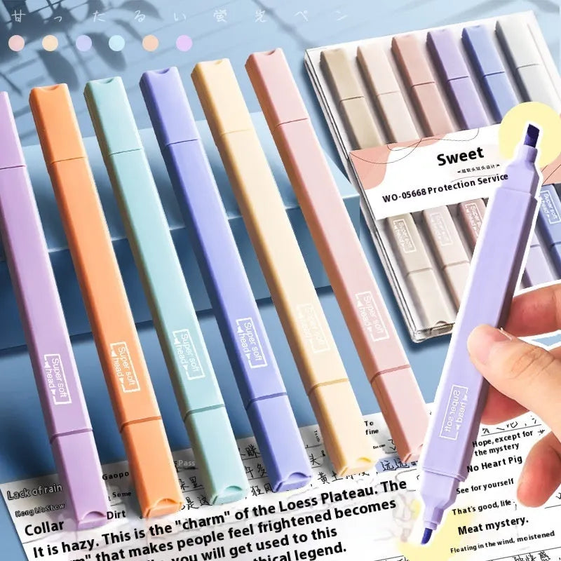 Set of six double-headed fluorescent highlighter pens with assorted barrel colours on a white surface.