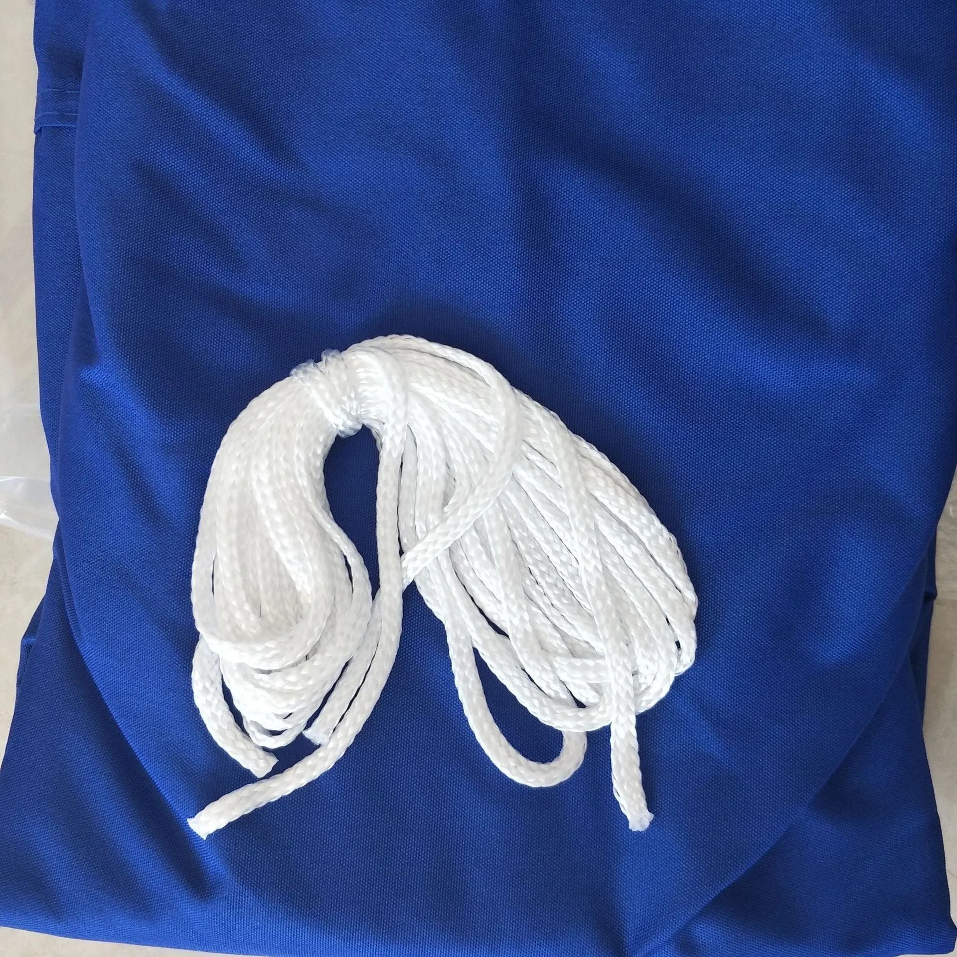 Curved square shade sail in blue colour providing outdoor UV protection
