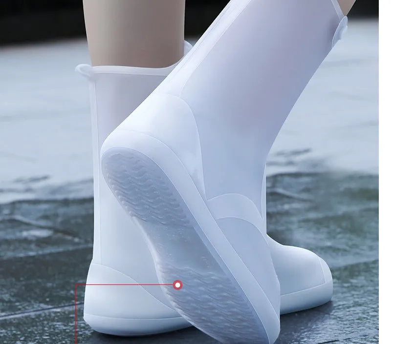 White PVC high-top reusable waterproof shoe cover for women, shown on a foot.
